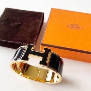 Hermès black and gold wide clic clac bracelet